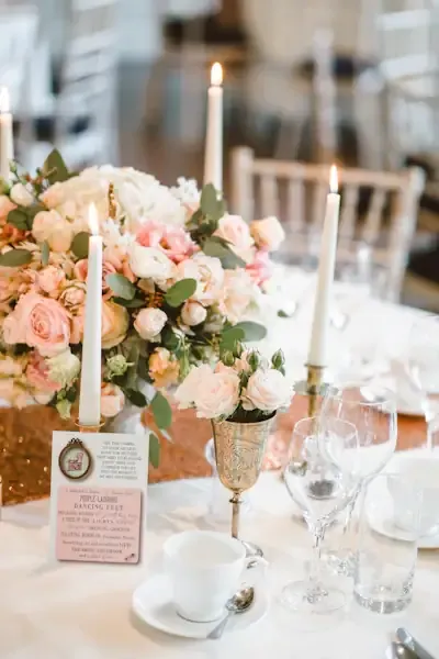 Blush rose reception centerpiece with taper candles